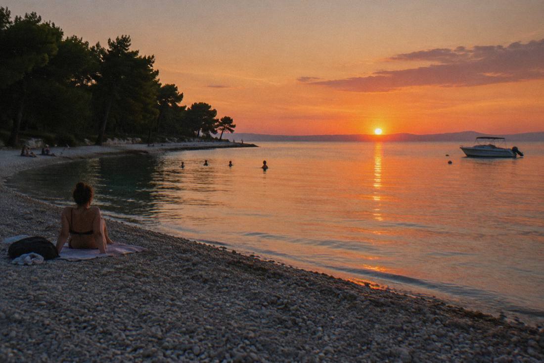 Kolovare pebble beach at sunset with pines and calm water