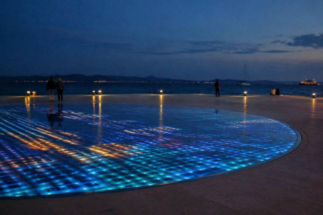 The glass circle of lights in the Zadar waterfront paving at night
