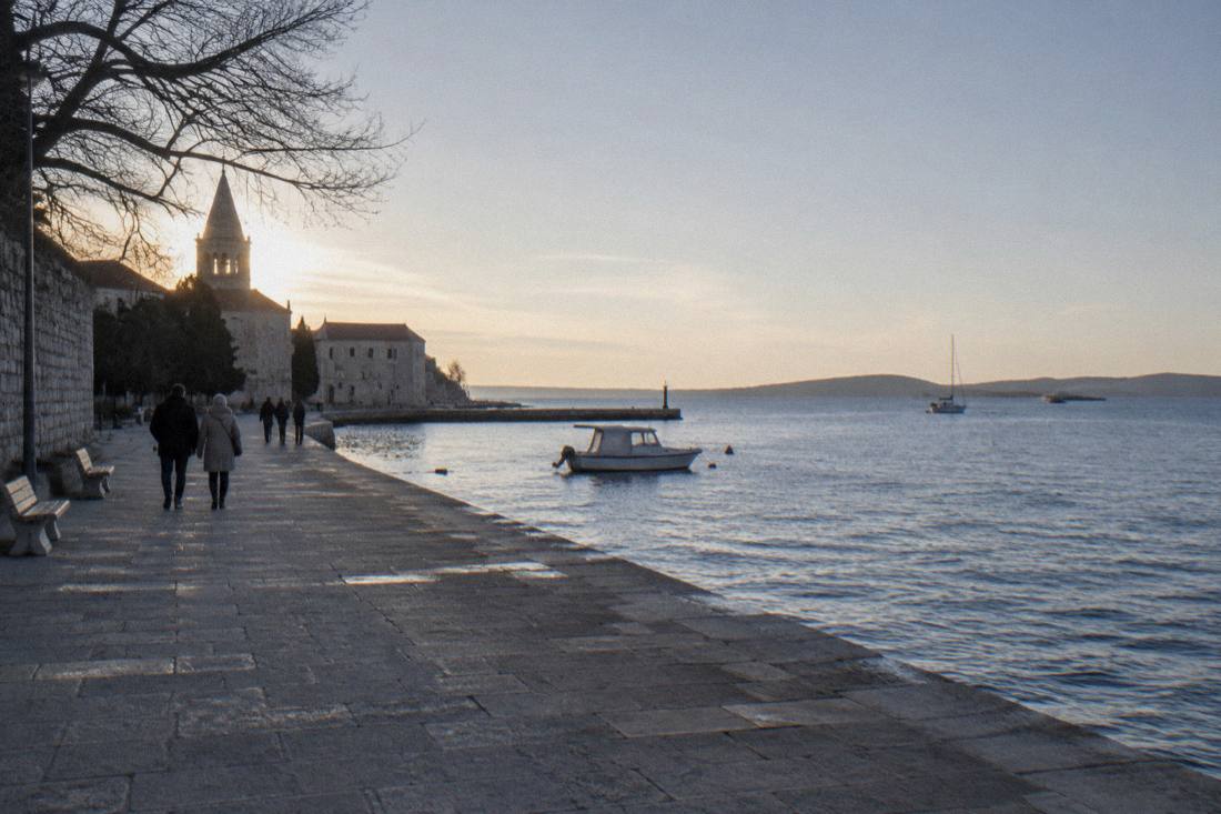 A quiet winter waterfront in Zadar with a grey-blue sea