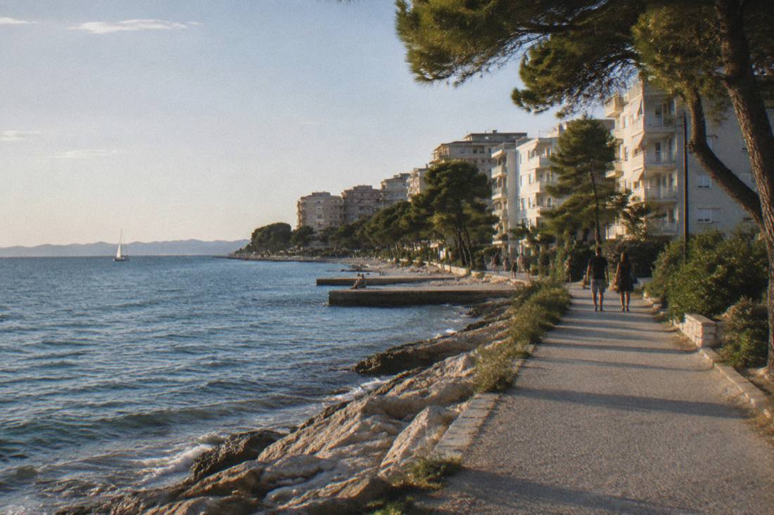 Apartment buildings among pines near the sea at Kolovare
