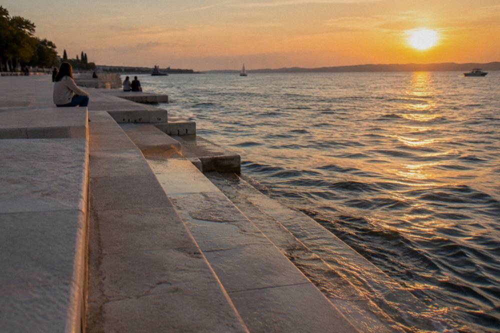 Marble steps down to the calm sea on a sunny afternoon