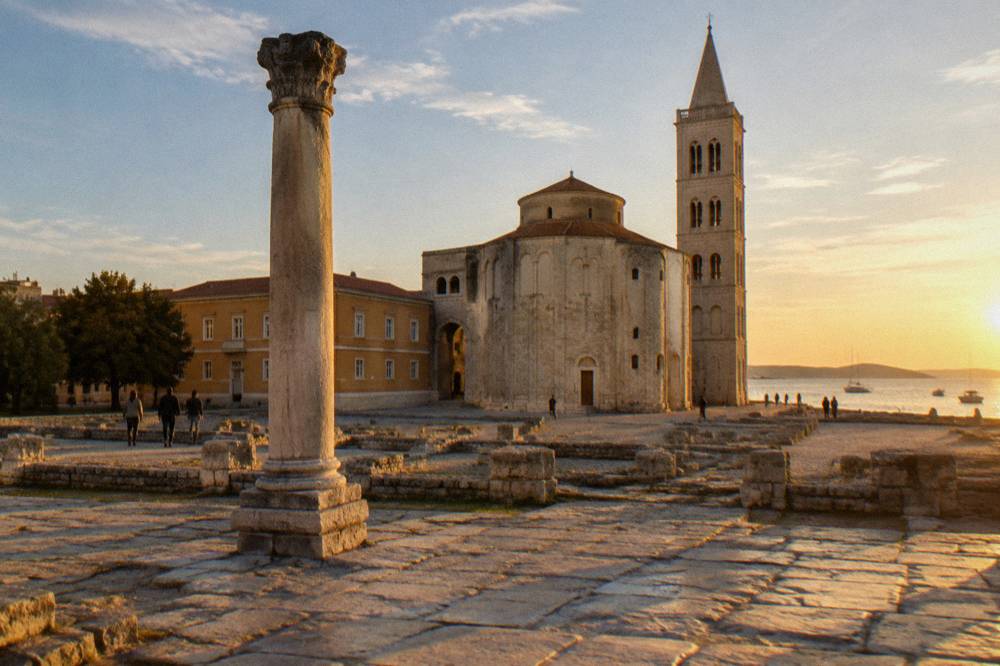 Roman forum with a standing column and round church in morning light