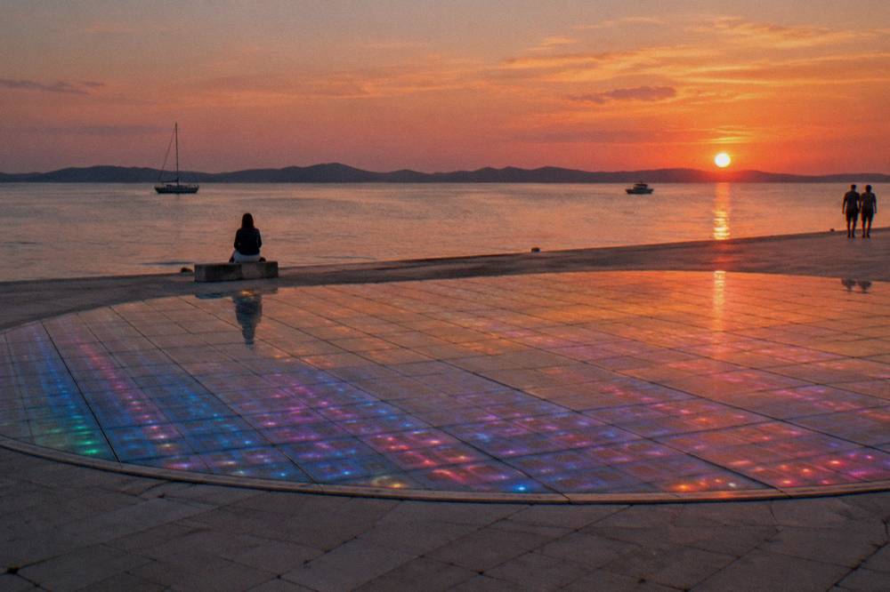 Glass-panel circle with coloured evening light by the sea in soft natural light