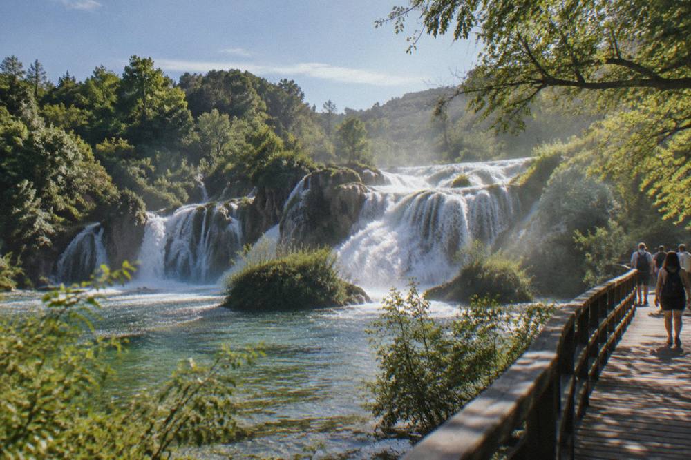 Krka travertine waterfalls with a wooden walkway and lush trees