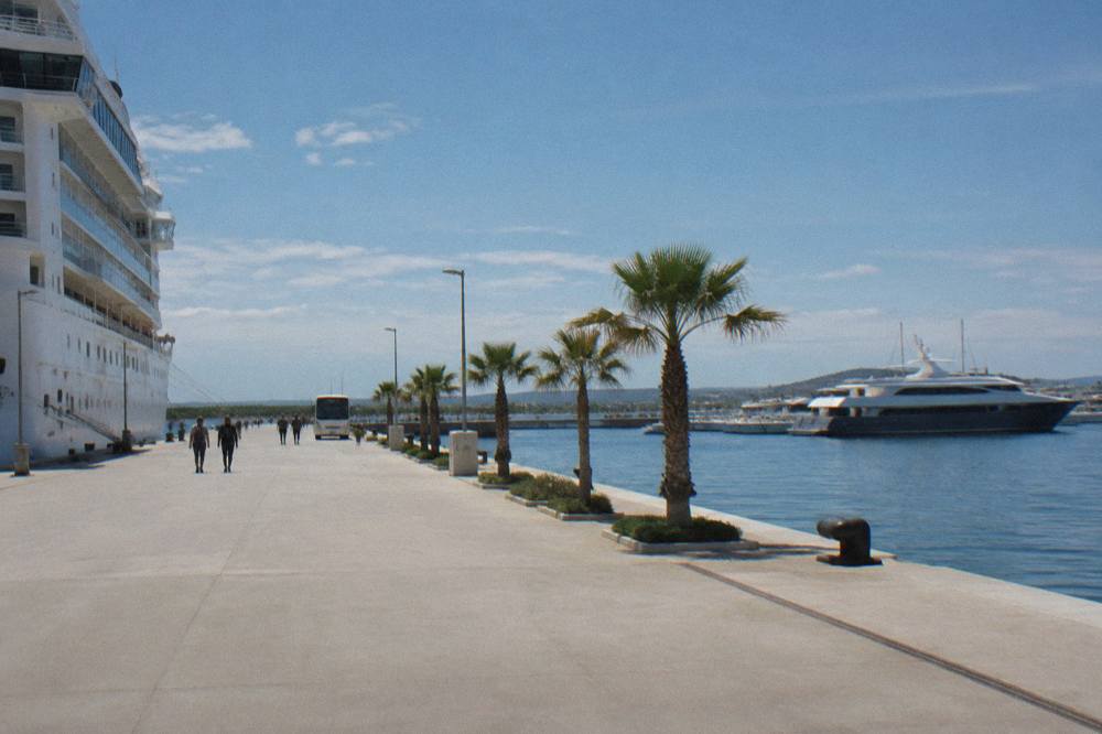 Ferry and cruise quay with wide paving and a distant shuttle bus
